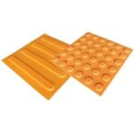 Two orange plastic mats with holes on them.