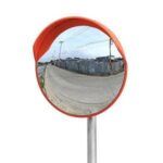 A round mirror on top of a pole.