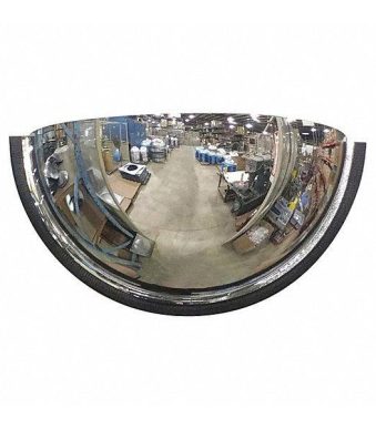 A Warrior Half Dome Mirror 90 Deg 60CM Dia WAR-HDM60-PM, resembling a warrior shield, hanging on the wall of a warehouse.
